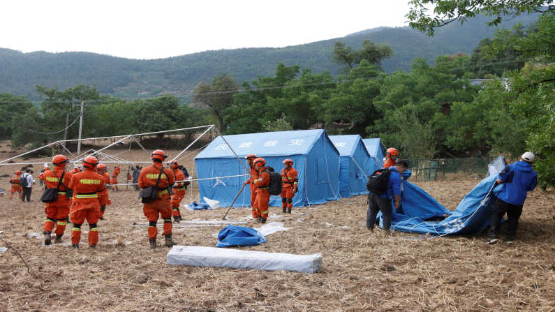 Firefighters set up temporary tents for people who are affected by the earthquake in Yangbi County, China’s Southwest Yunnan provenance. Over 70 thousand people were affected and over 20 thousand houses were damaged due to the earthquake. (PC: China OUT)]